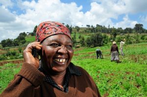 a-kenyan-farmer-uses-a-mobile-phone-in-the-field-neil-palmer-ciat